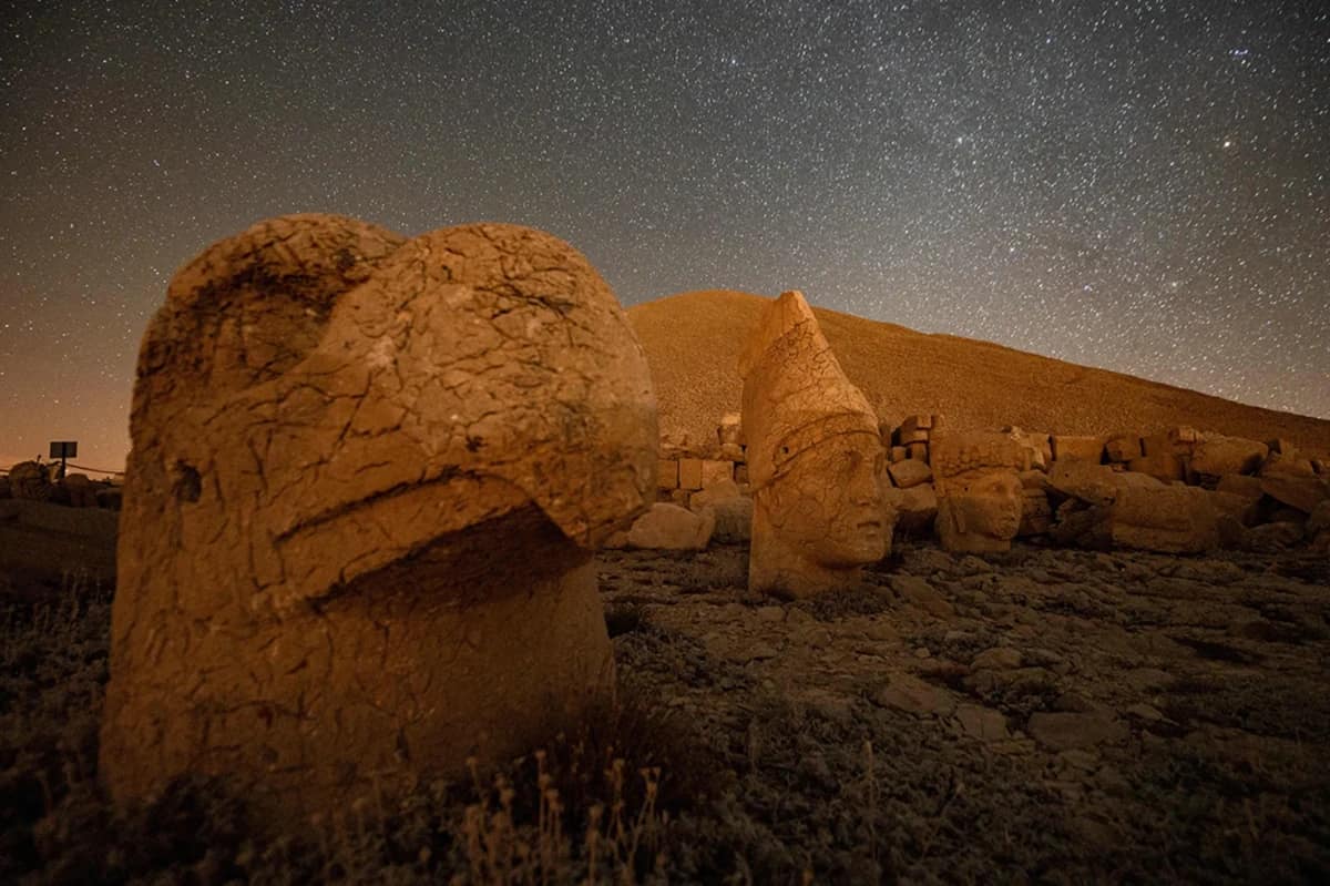 The toppled stone heads of gods and a king resting on the ground at Mount Nemrut